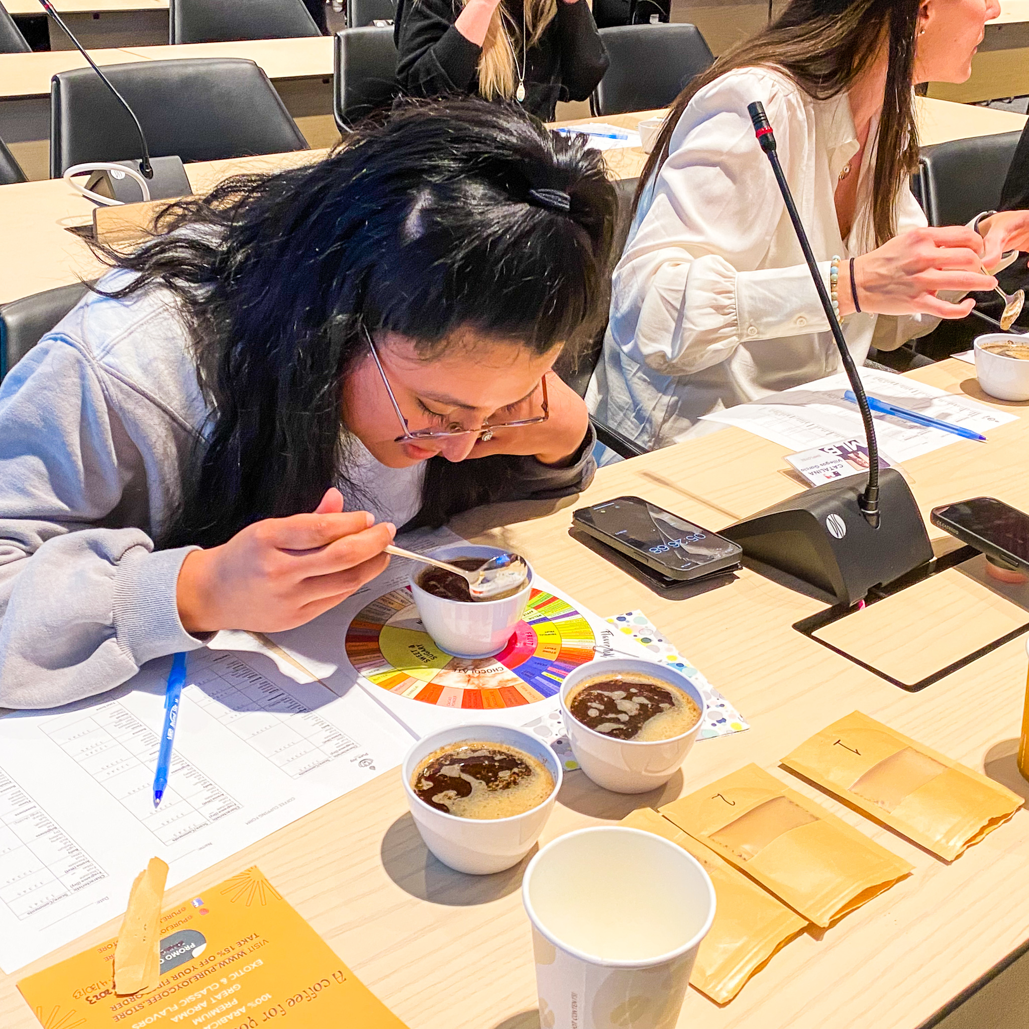 Person tasting coffees during a specialty coffee cupping by Pure Joy Coffee